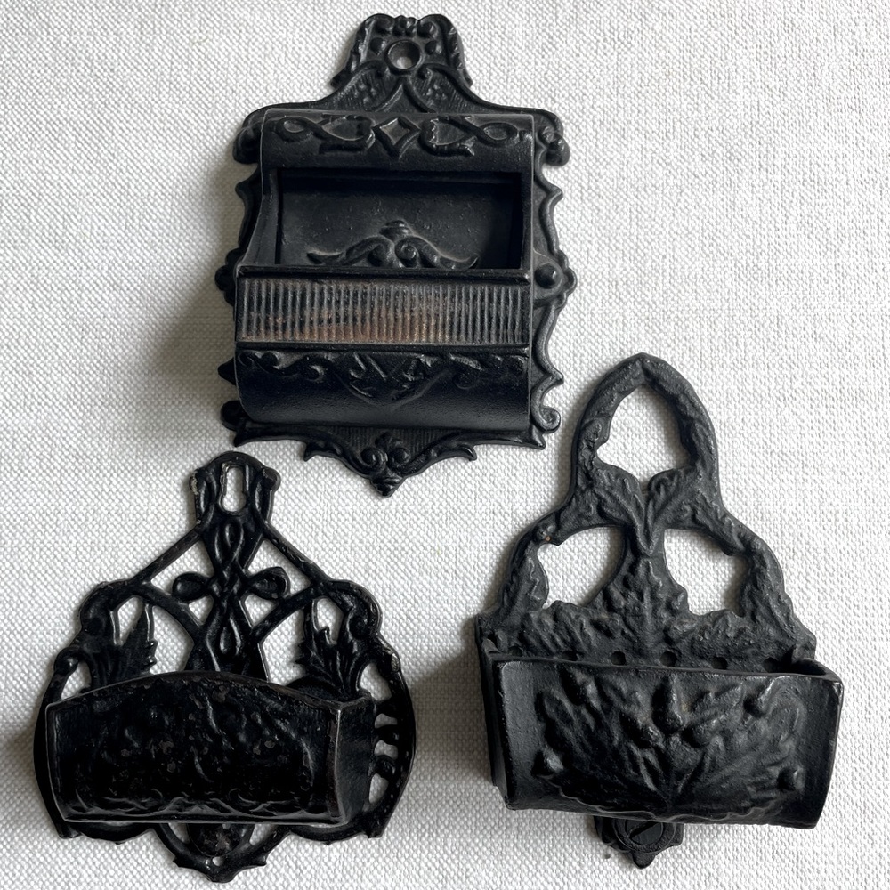 Set of 3 antique cast iron match holders, one with match strike